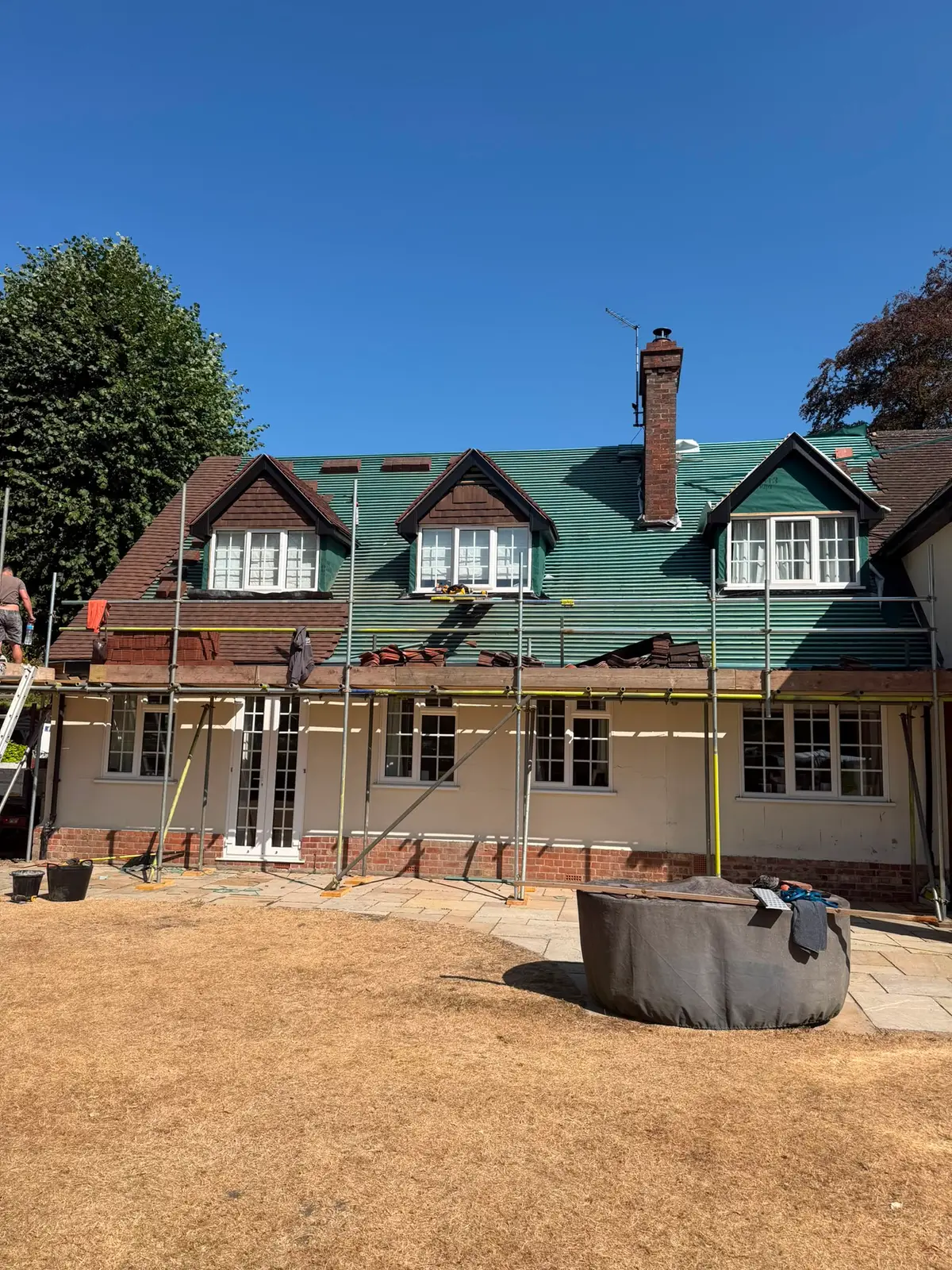 Full re-roof in progress on a large detached home near Newbury