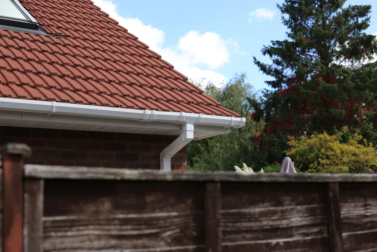 White guttering downpipe tiled roof