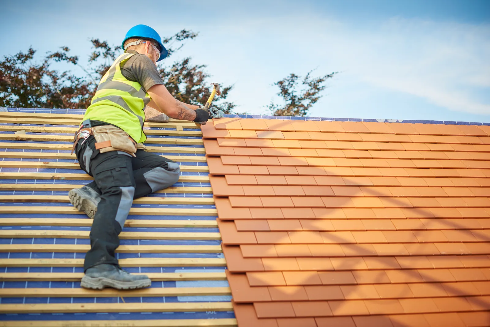 Tiled slate roofer fitting clay tiles pitched roof